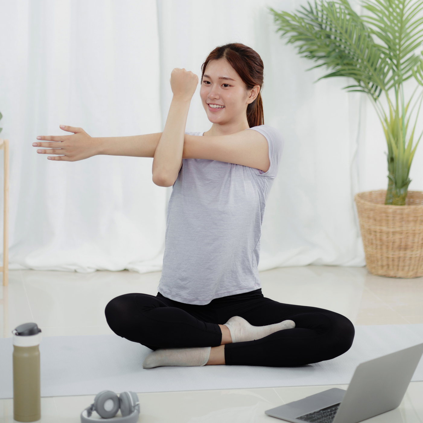 Young asian woman attractive exercises workout at home and watch